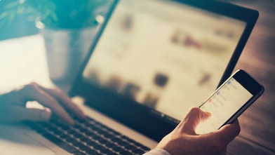 Man using laptop and phone