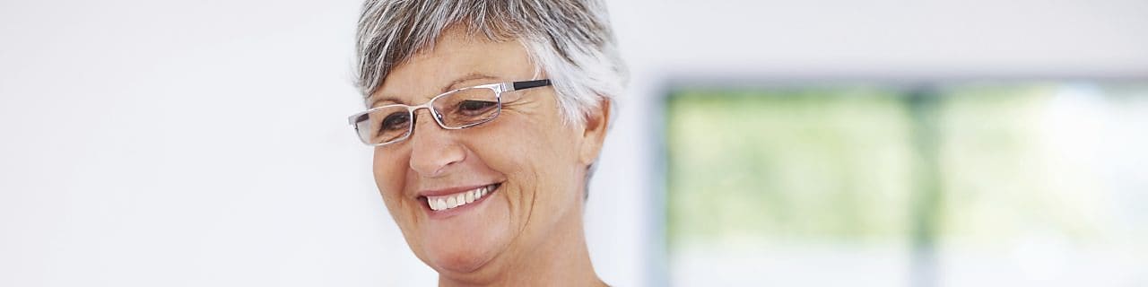 Smiling woman using laptop at home