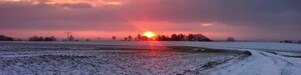 Sunrise on a snowy road and field