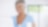 Smiling lady with cup of drink looking at her computer screen