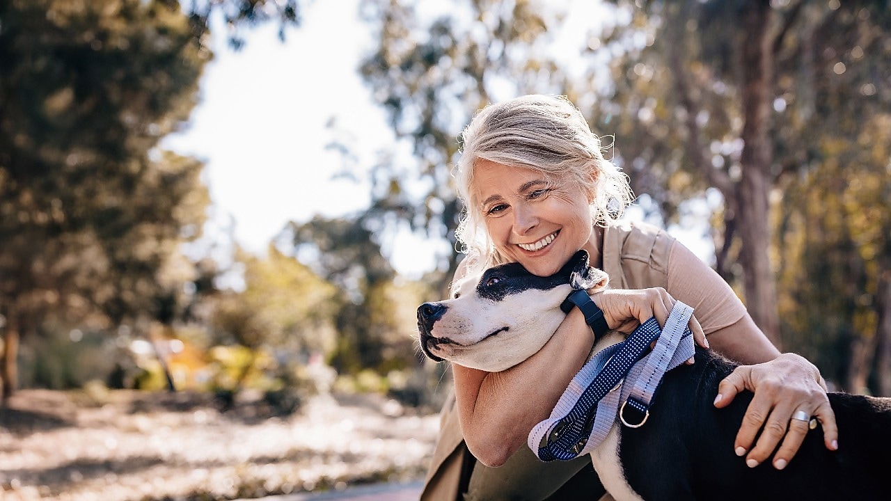 A person holding a dog