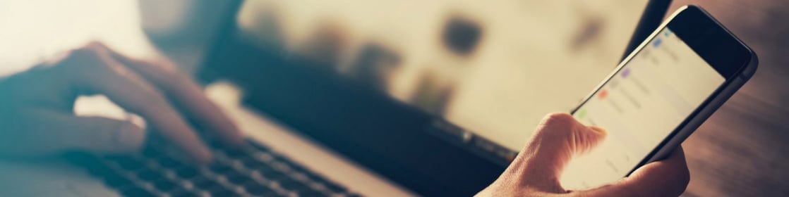 Man using laptop and phone